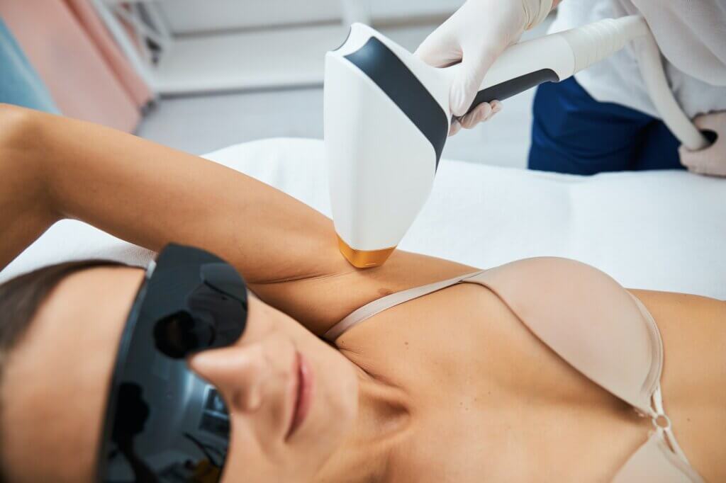 Serene client undergoing an underarm laser hair removal